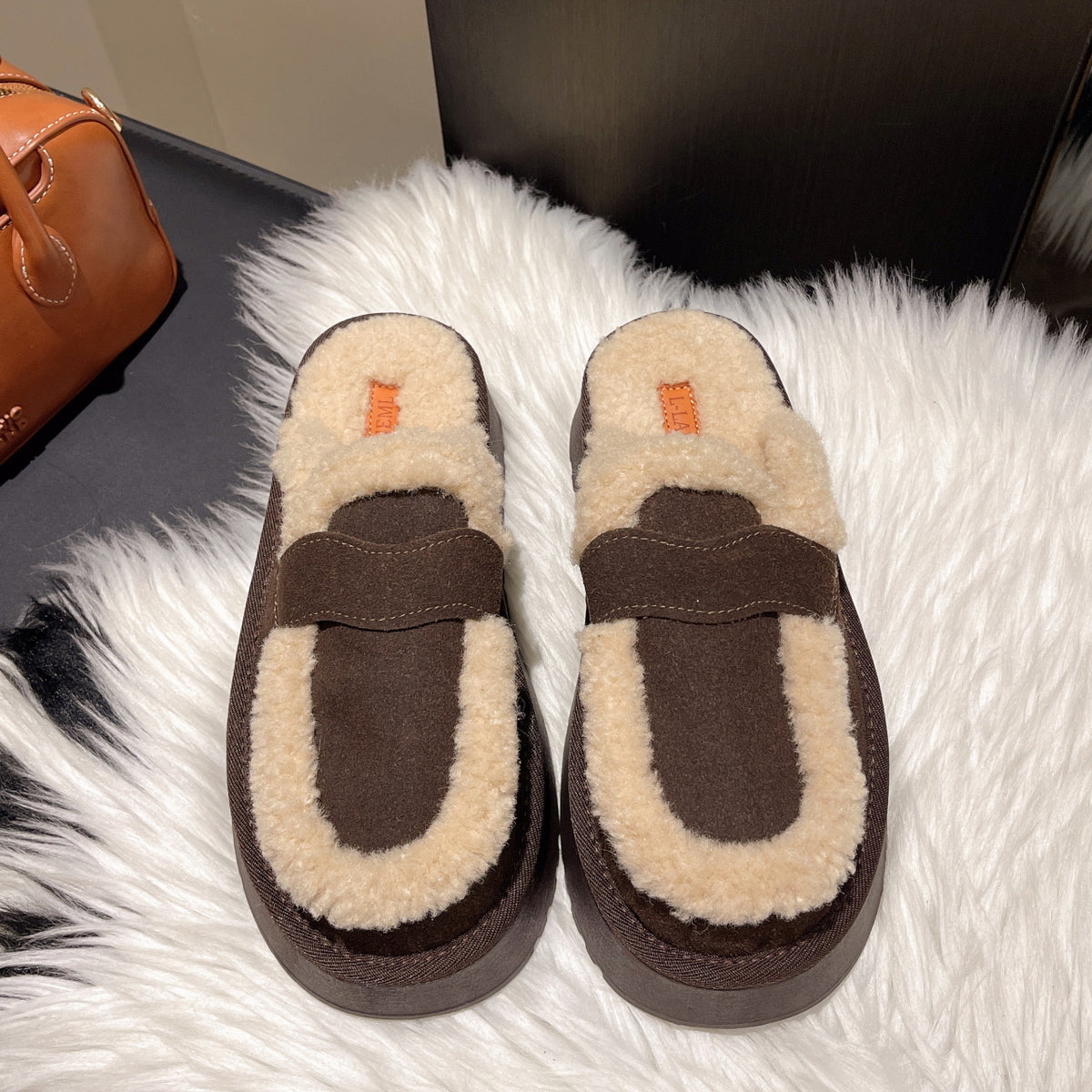 Fur-lined brown platform clog slippers with back strap and beige sherpa trim