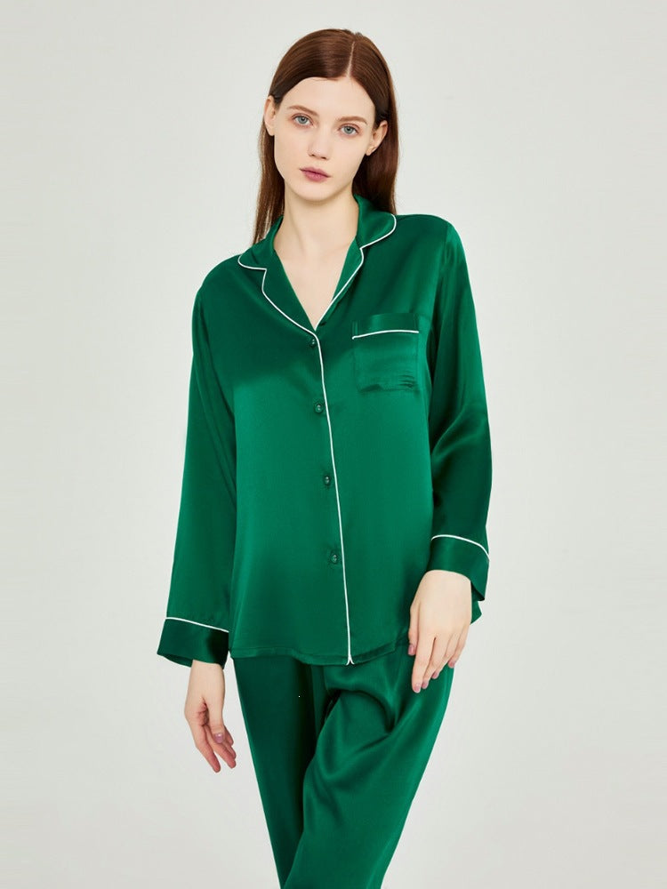 Emerald green silk pajama set with piped button-up shirt and matching pants