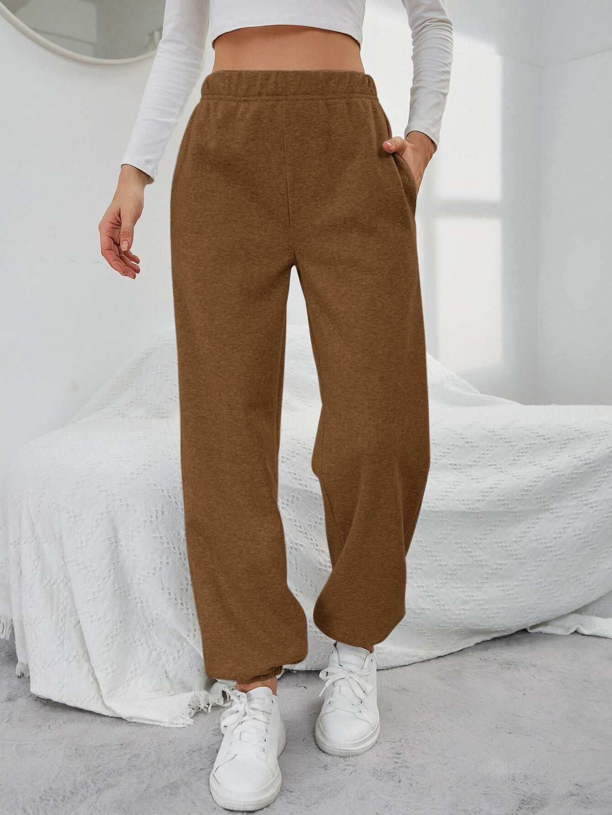 Brown high-waisted straight-leg sweatpants with side pockets and elastic waistband