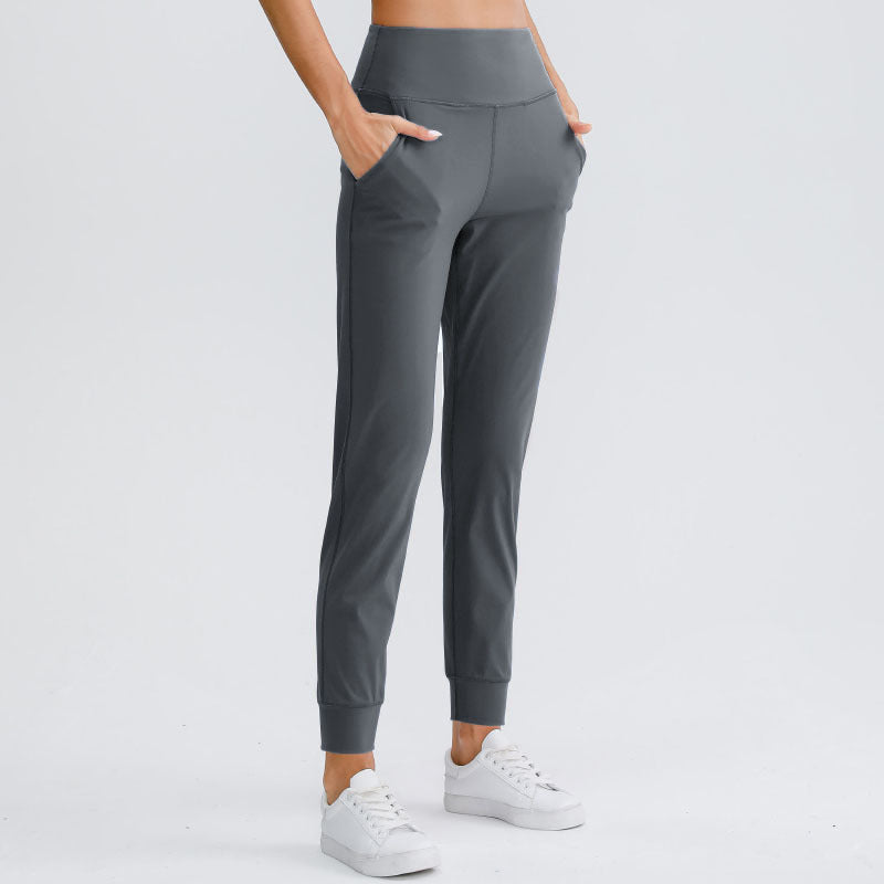 Women's dark gray yoga pants with elastic waistband and tapered ankle-length legs
