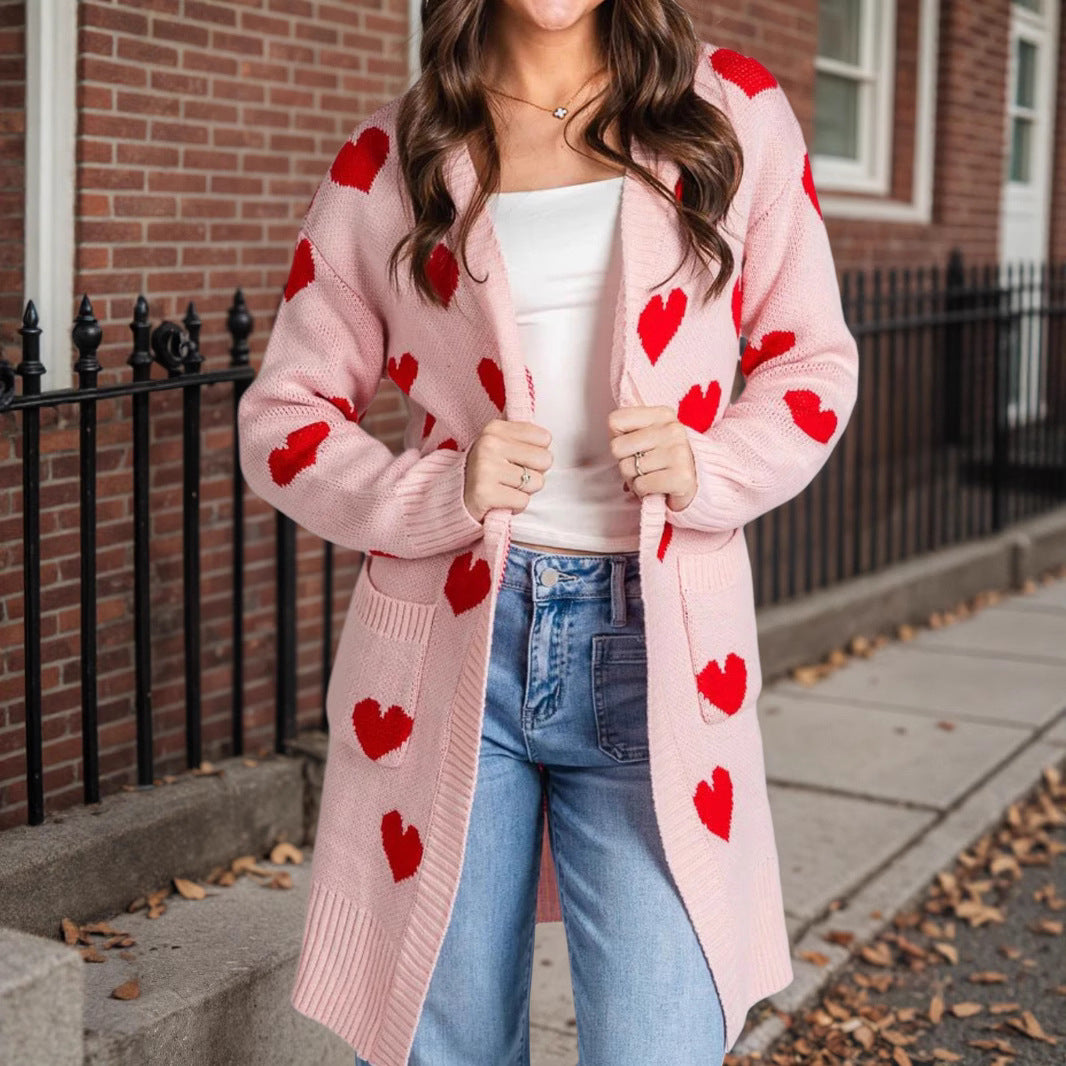 Pink knit cardigan with red heart pattern, open front, long sleeves, mid-length