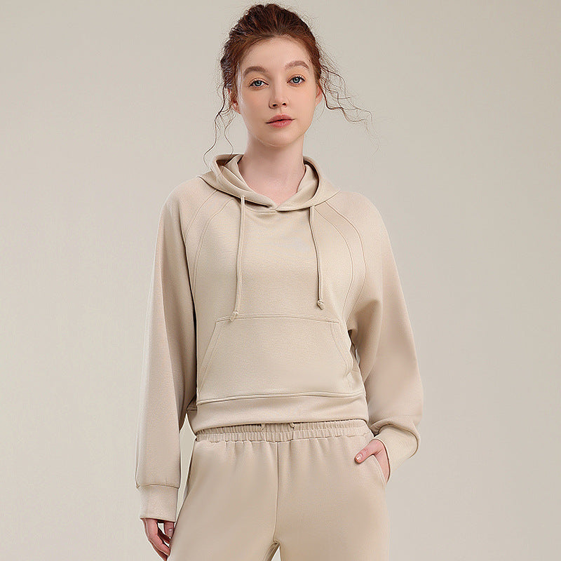 Beige hooded sweatshirt and matching sweatpants set with drawstring hood and elastic waist