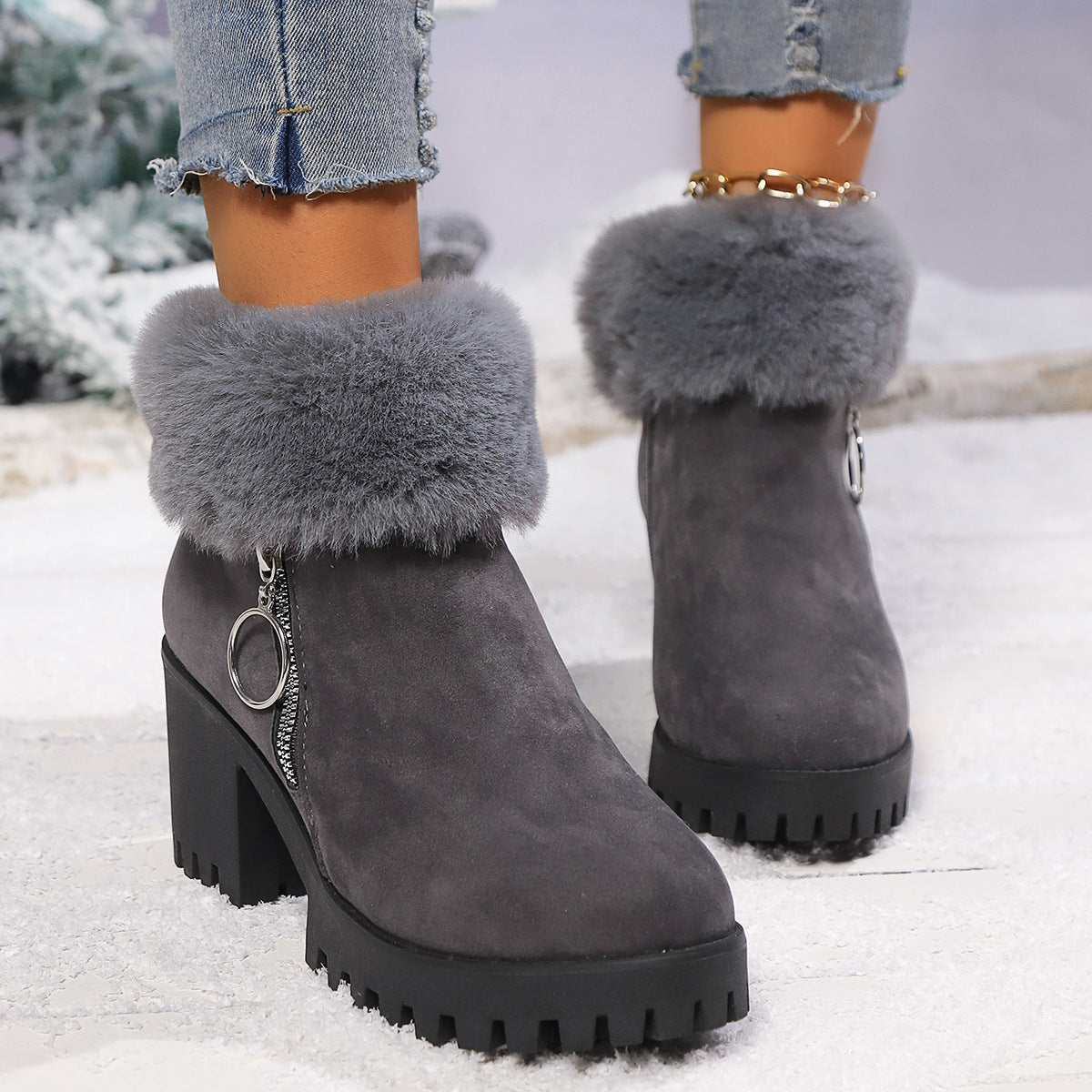 Dark gray suede snow boots with faux fur ankle cuff and side zipper, chunky tread heel.