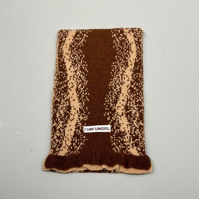 Brown speckle knitted scarf with fringed bottom edge and small label patch