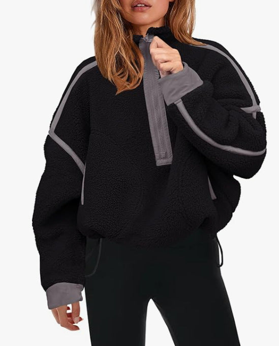 Plush quarter-zip sweatshirt in black with gray trim and pull tab