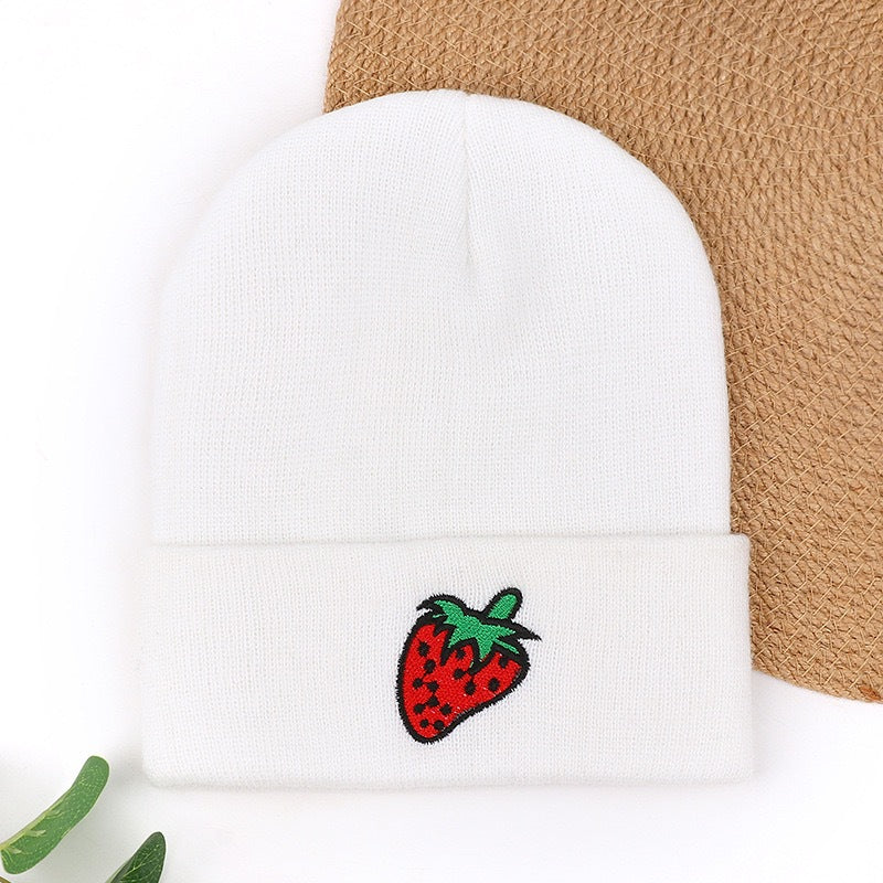 White knit beanie with red strawberry embroidery