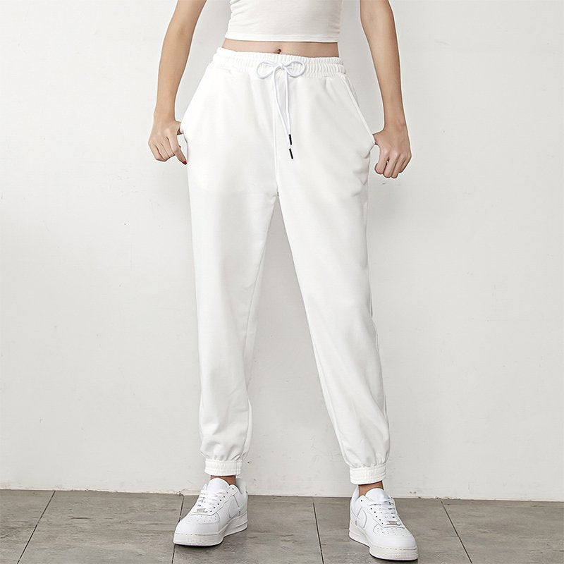 White high-waisted jogger sweatpants with drawstring, elastic cuffs, tapered legs