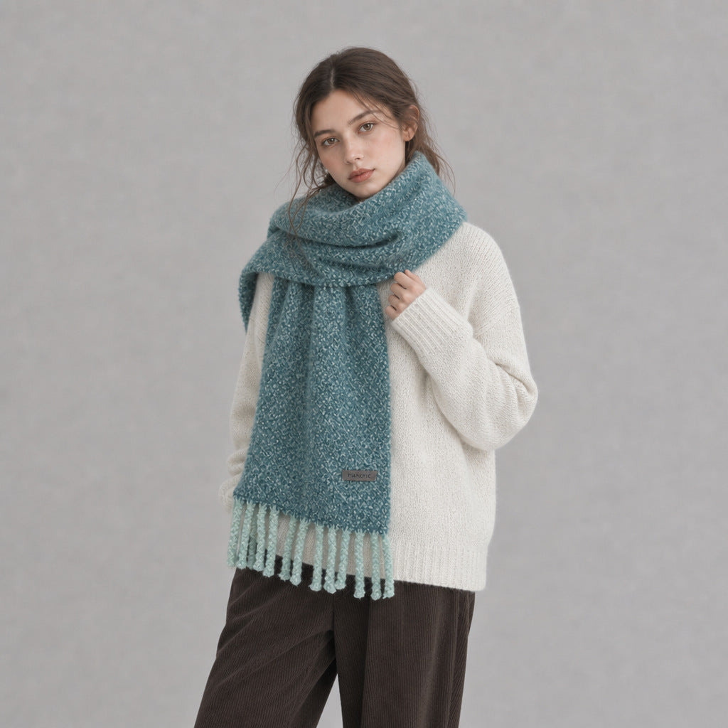 Chunky loop-knit scarf shawl in lake blue with fringed ends and short stitched emblem