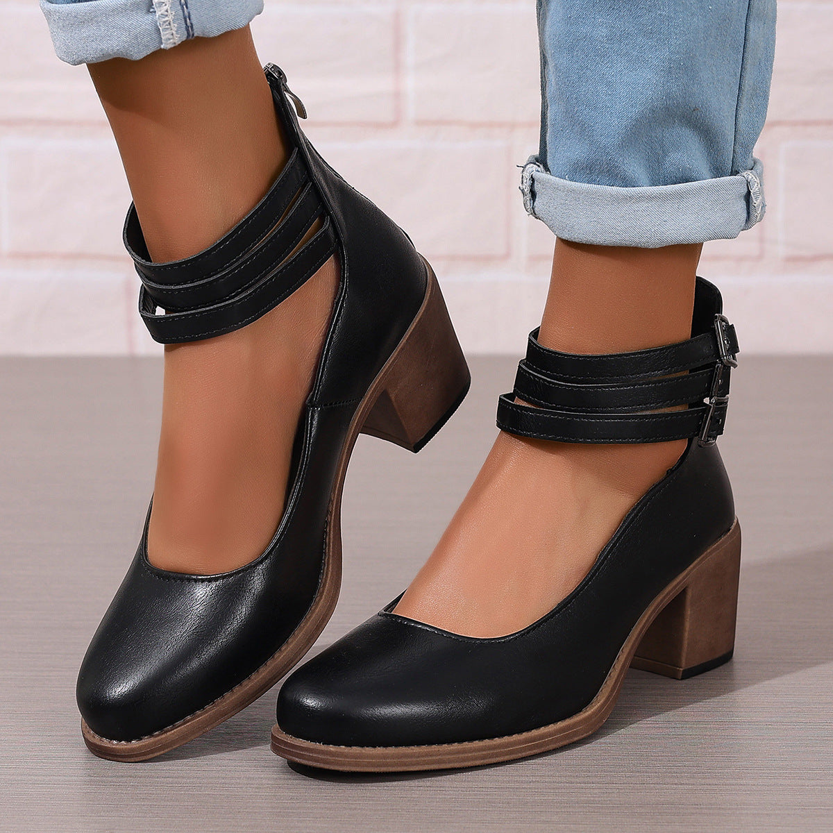 Black ankle boots with stacked heel and double ankle strap buckles