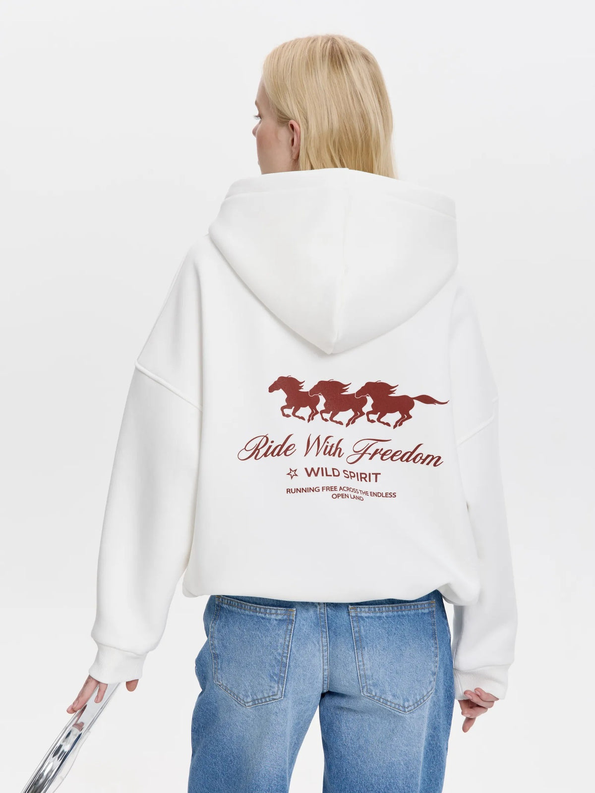 White oversized hoodie with horse graphic and 'Ride With Freedom' back print