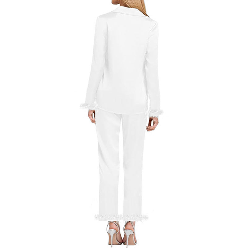 White long-sleeve pajama top and pants set with feathered cuffs, back view