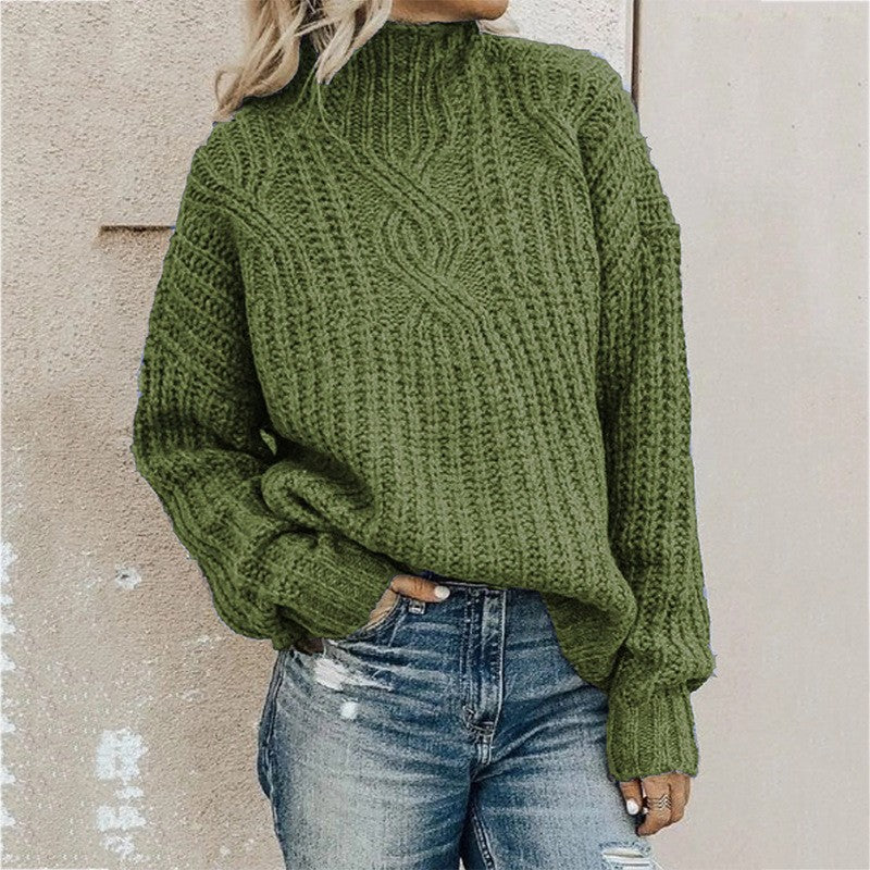 Women's green cable knit turtleneck sweater with long sleeves and ribbed cuffs