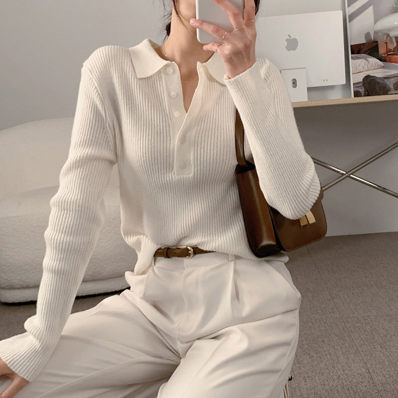 White knit polo collar long-sleeve top with button placket and ribbed texture.