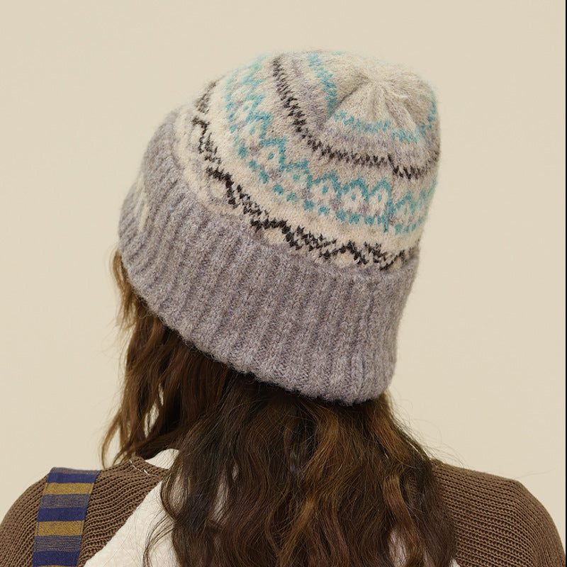 Light gray knit beanie with turquoise Fair Isle pattern and ribbed cuff