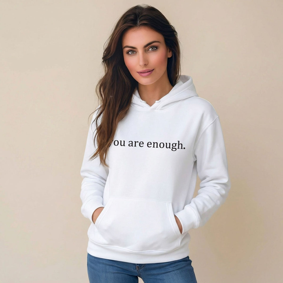 White women’s hoodie sweatshirt with hood, front pocket, and 'you are enough' print.