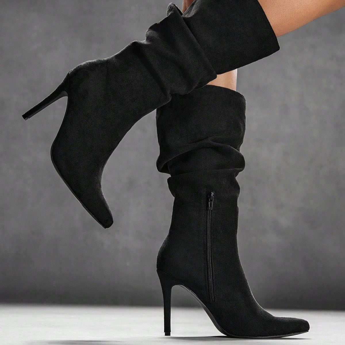 Black suede over-the-knee stiletto boots with ruched shaft and pointed toe, side zip