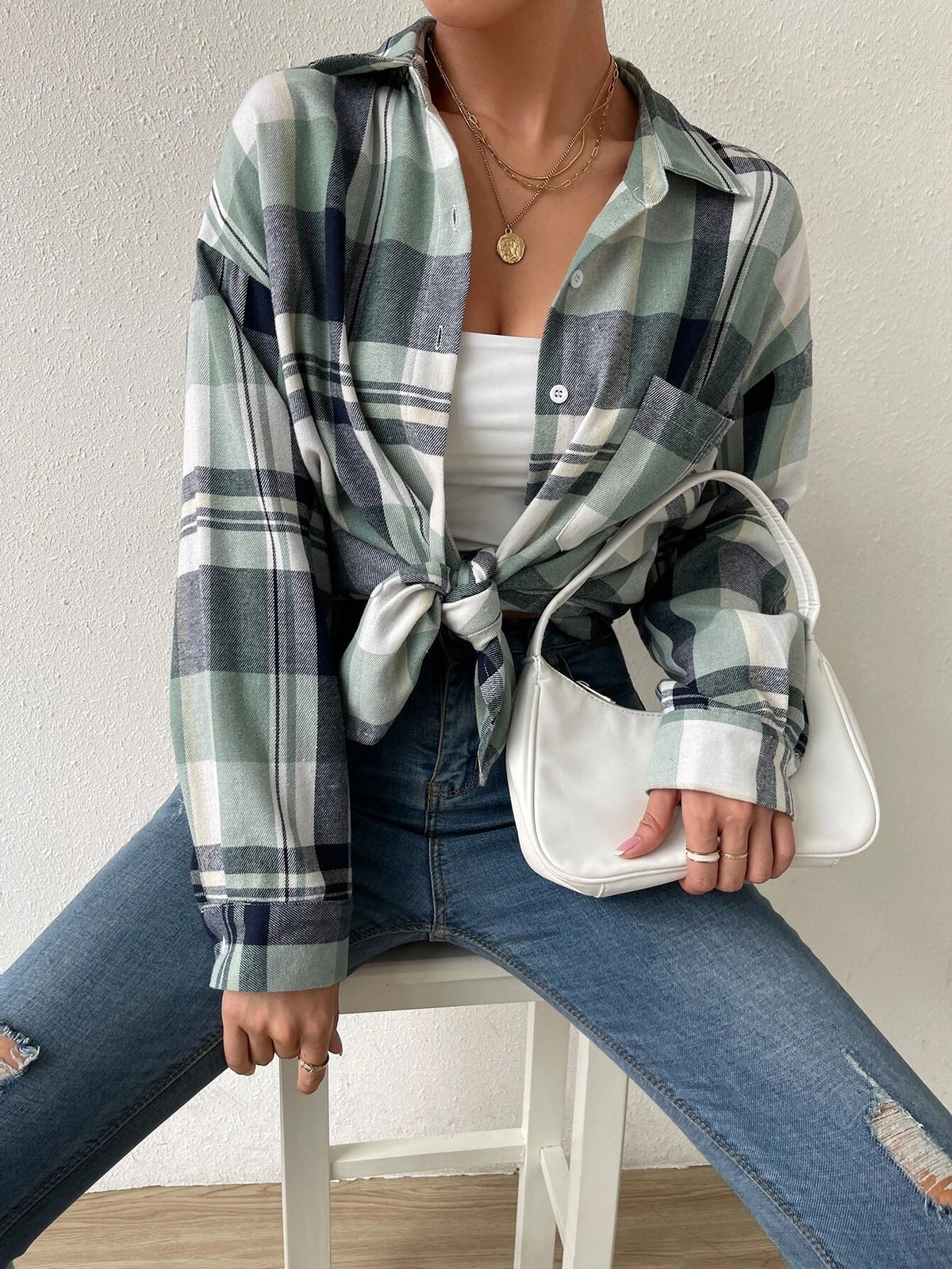 Women’s green and black plaid flannel button-down shirt with long sleeves and buttons
