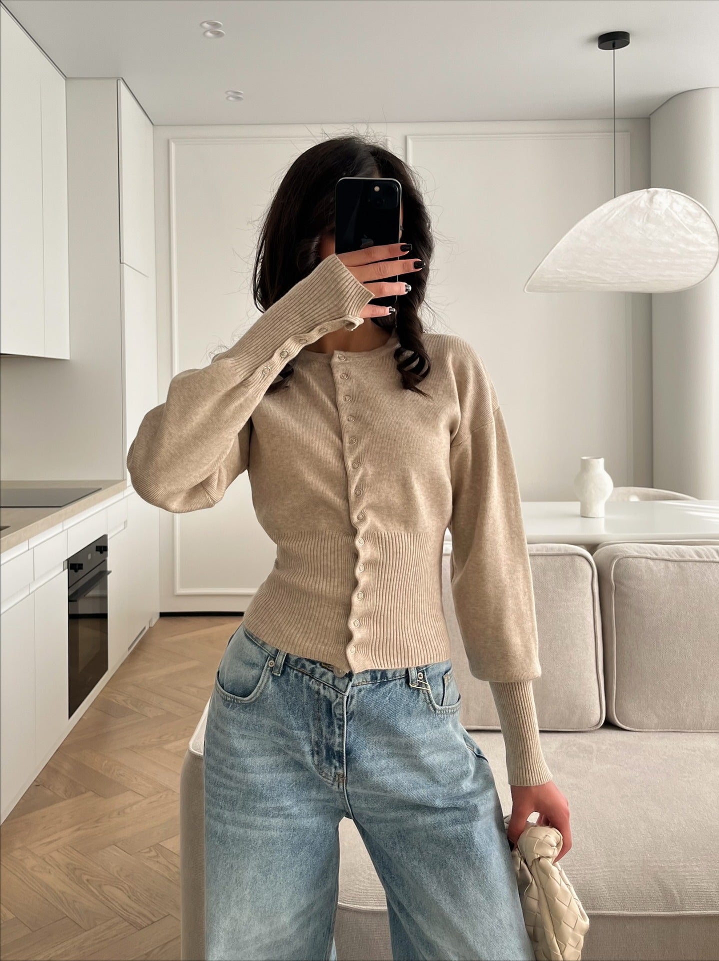 Women’s beige knitted cardigan sweater with button-front and ribbed cuffs