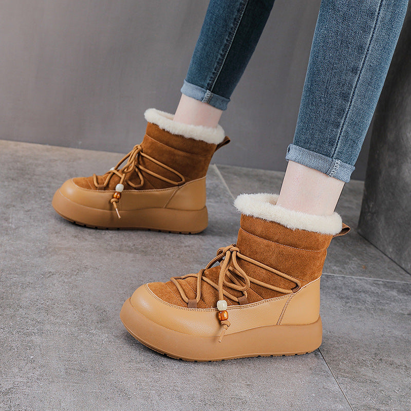 Brown snow boots with thick sole, lace-up front, and fuzzy cuff trim