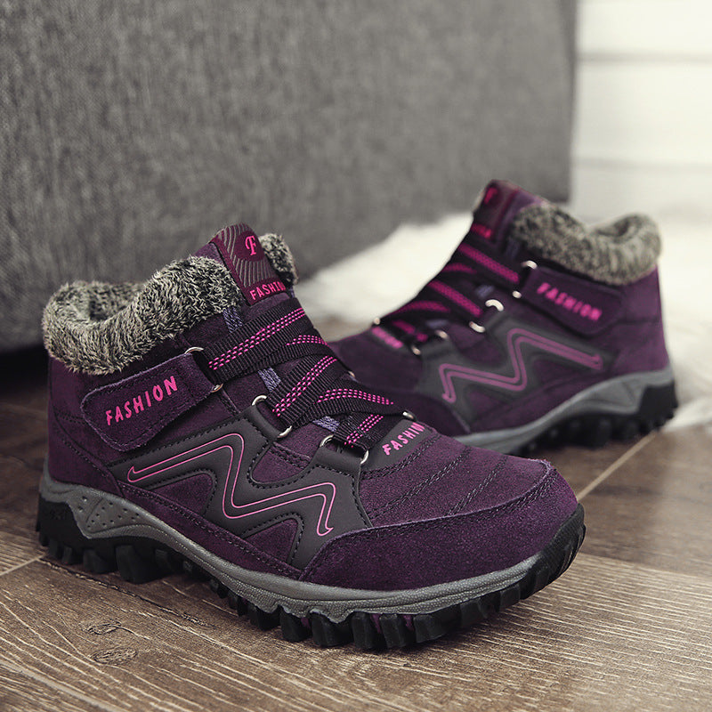 Purple winter snow boots with faux fur lining, adjustable straps, and chunky traction sole