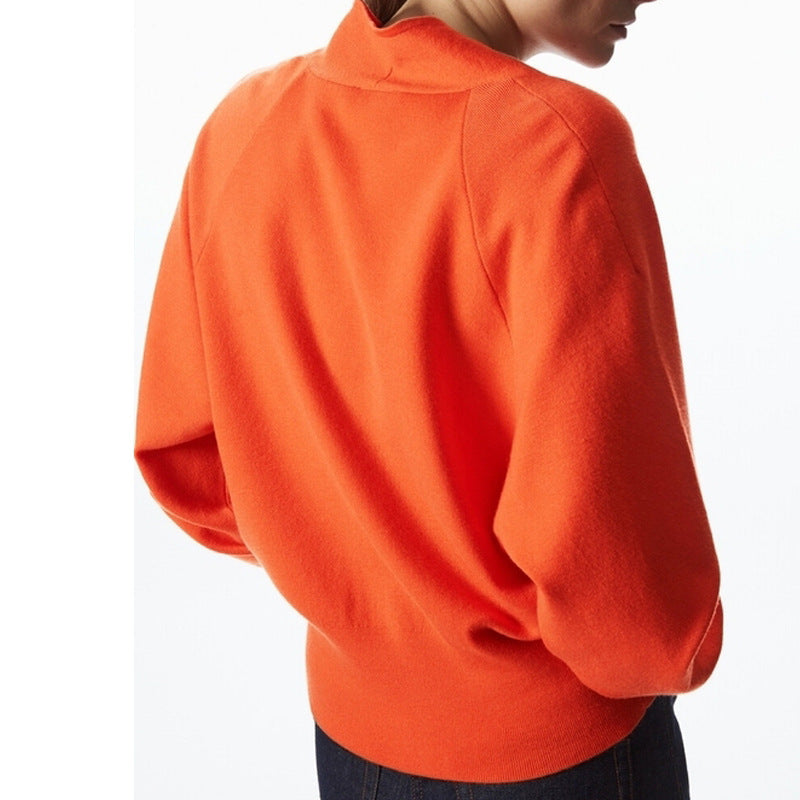 Orange v-neck cardigan sweater back view with ribbed yoke and long sleeves