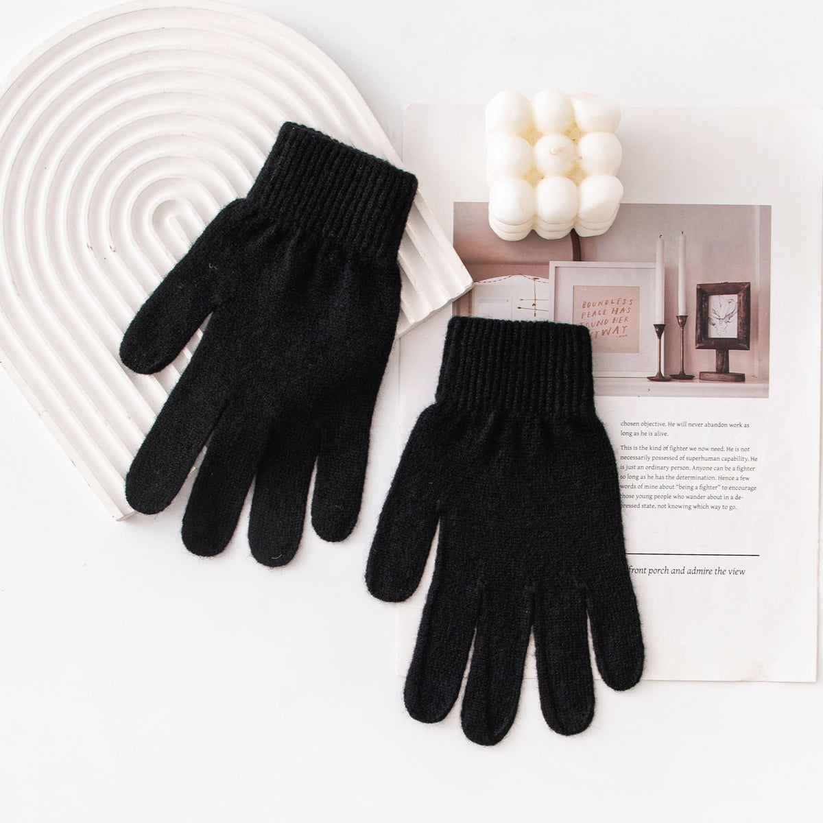 Pair of black knitted gloves with ribbed cuffs and full-finger coverage.