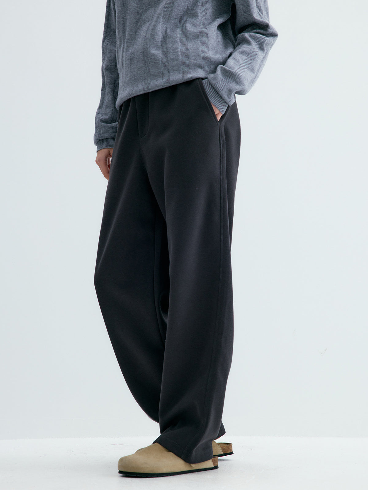 Black loose knit sweatpants with straight wide legs and elastic waistband