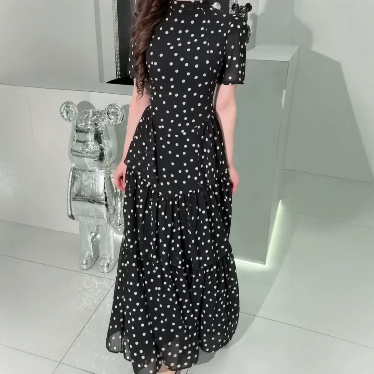 Black polka dot maxi dress with high neck, short puff sleeves, tiered ruffle hem