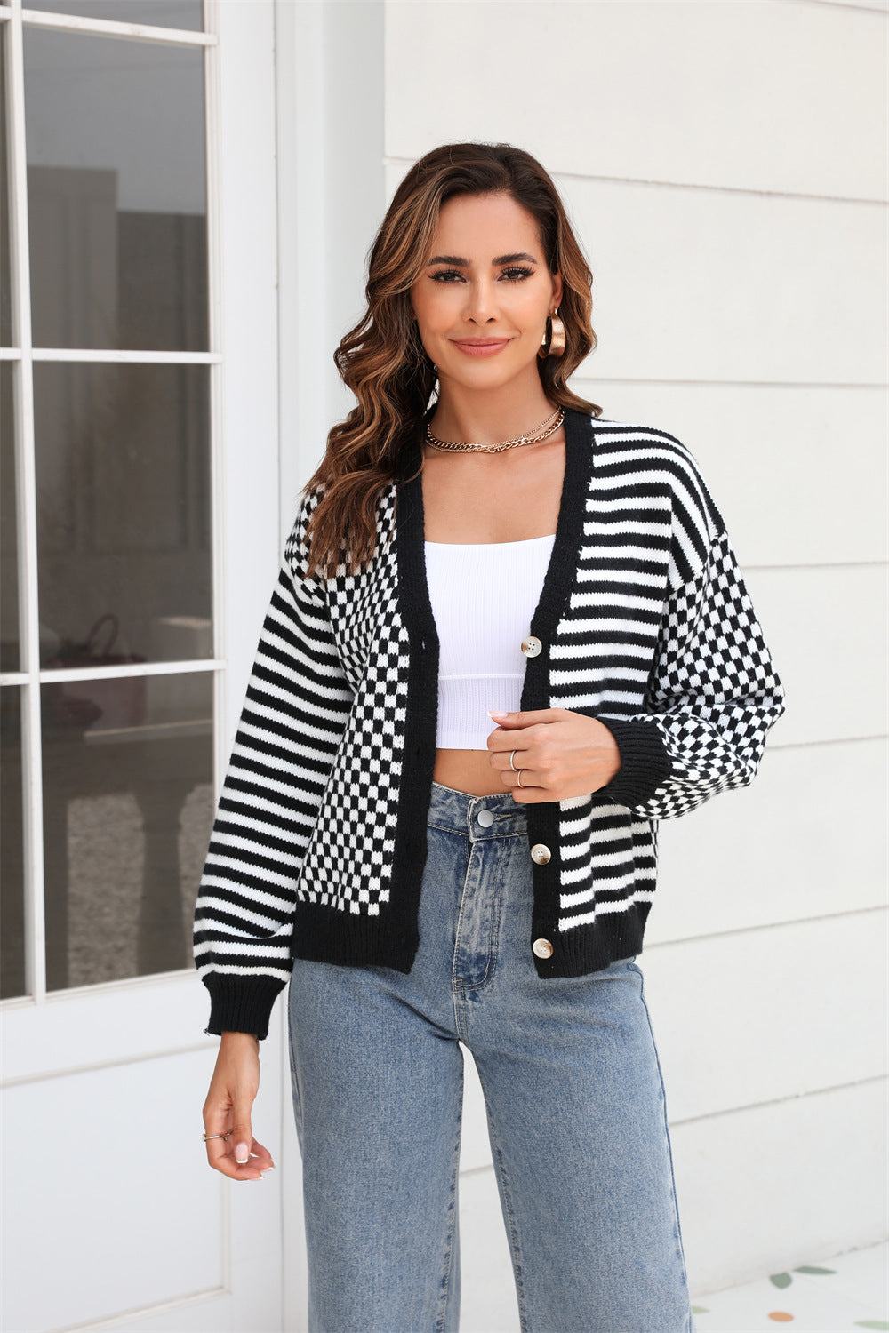 Women’s black-and-white checker knit cardigan with button front and ribbed cuffs
