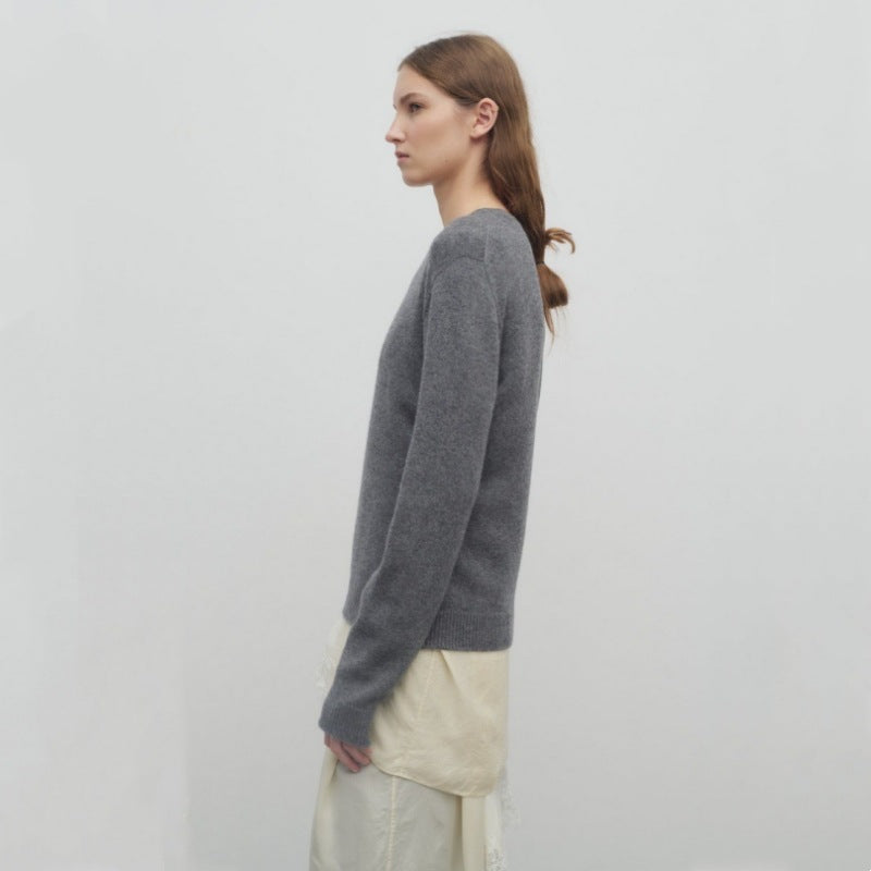Women's gray knit pullover, long sleeves and crew neck shown from the side