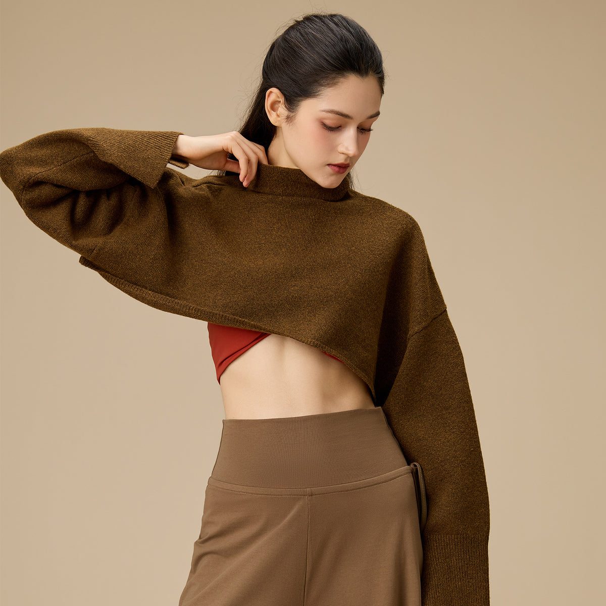 Brown cropped turtleneck yoga blouse with long sleeves, draped hem