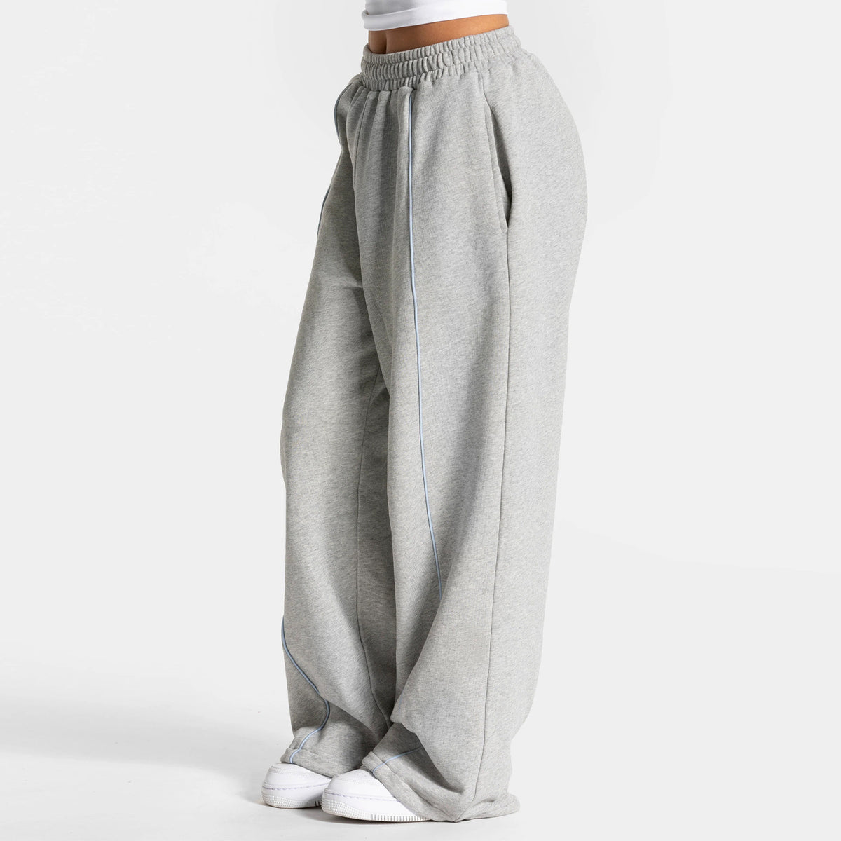 Women's loose gray yoga pants with elastic waistband and light blue contrast lines