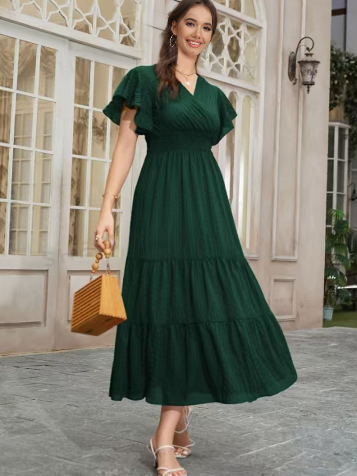 Dark green V-neck tiered midi dress with short puff sleeves and layered skirt