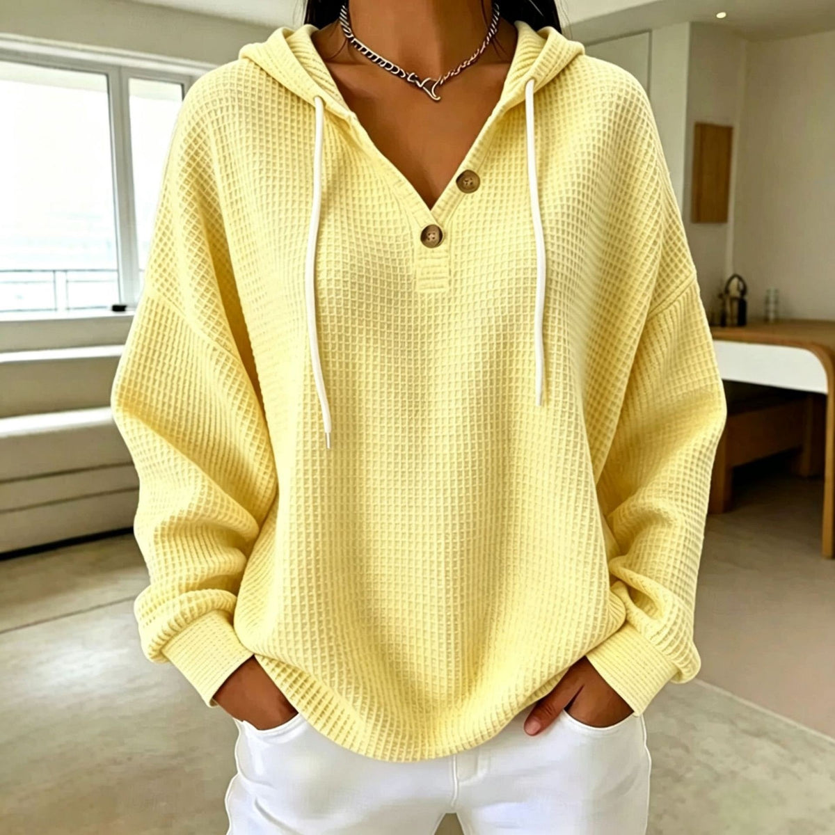 Women\u2019s waffle-knit drawstring hoodie with henley button placket, yellow hood and long sleeves