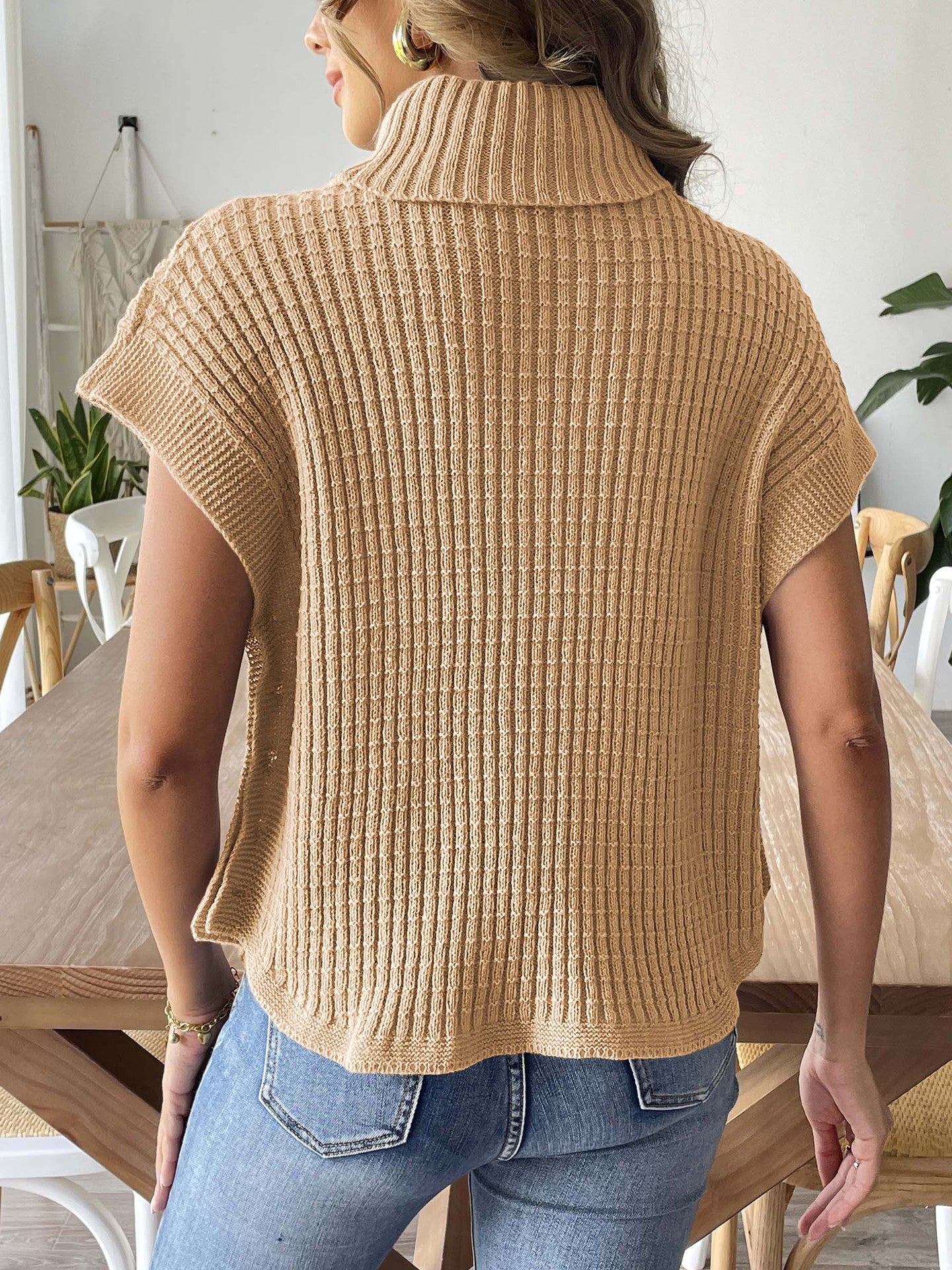 Beige knit high-neck sweater vest with ribbed texture and short-sleeve drape, back view