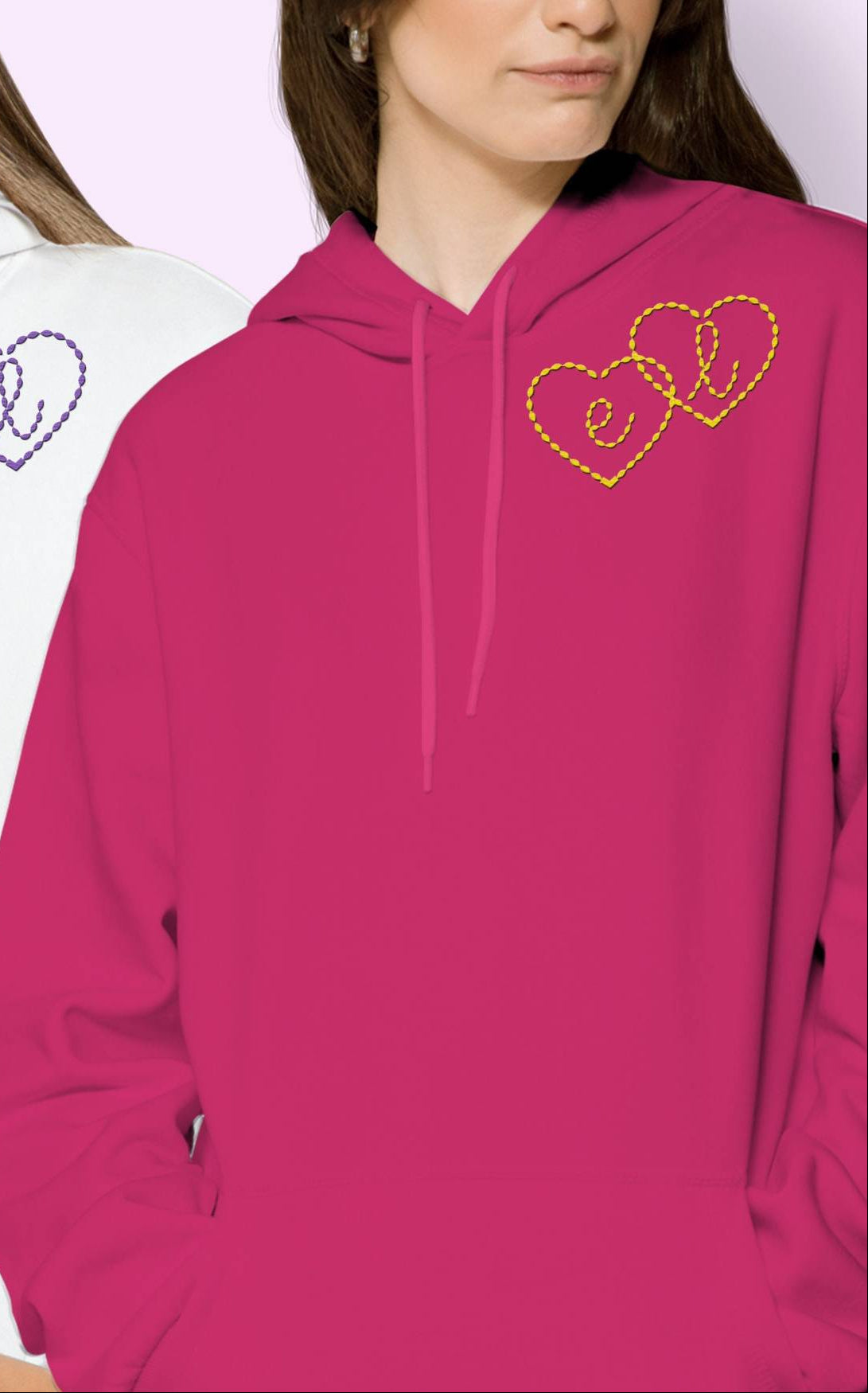 Pink heart hoodie with multi-color embroidered heart design on the chest