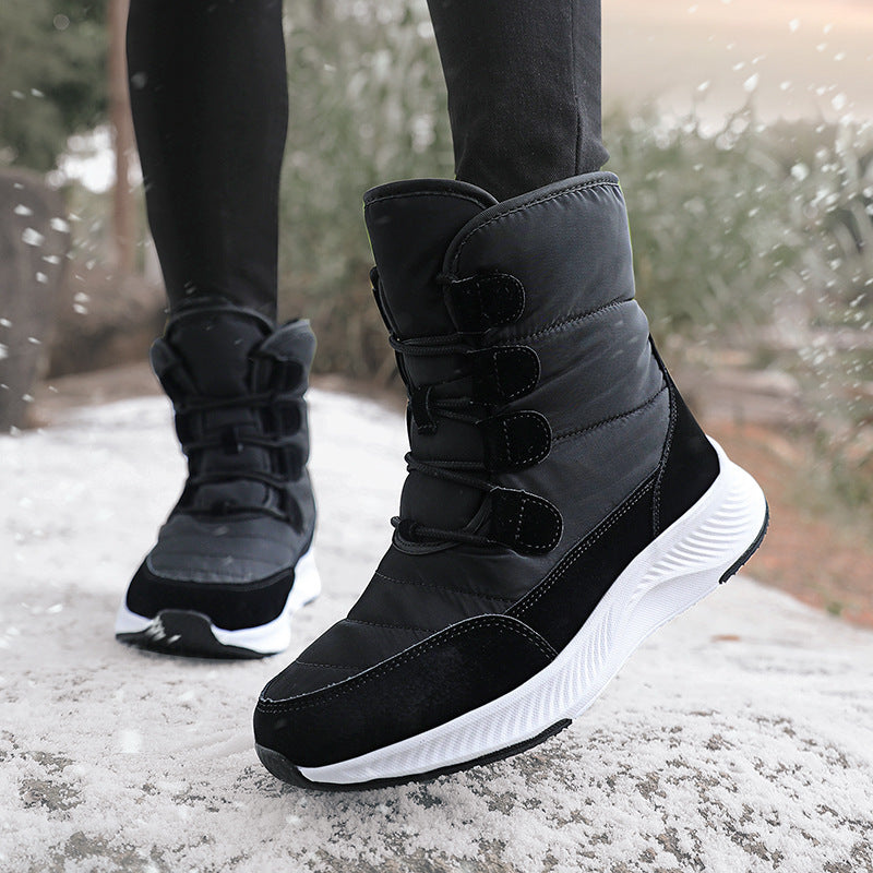 Black high-top snow boot with fleece lining, hook-and-loop straps, and textured rubber sole