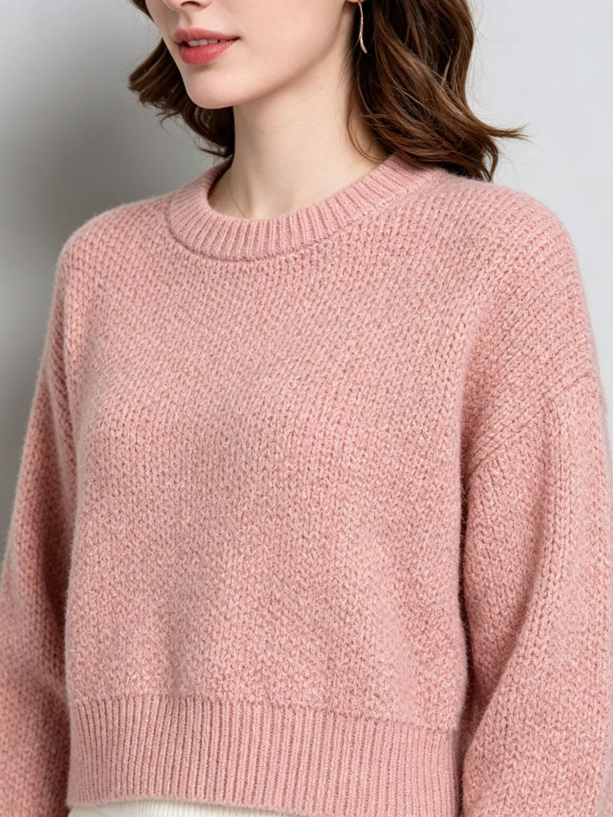 Pink knit pullover sweater with crew round neck, long sleeves, ribbed cuffs and hem