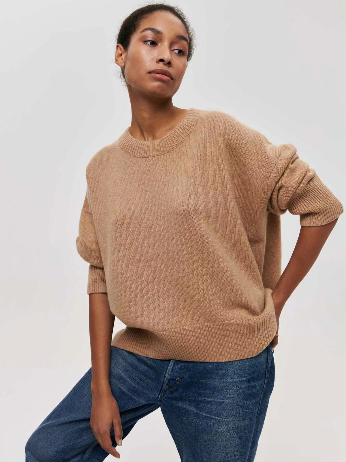 Camel sweater with rolled sleeves and ribbed hem, paired with jeans