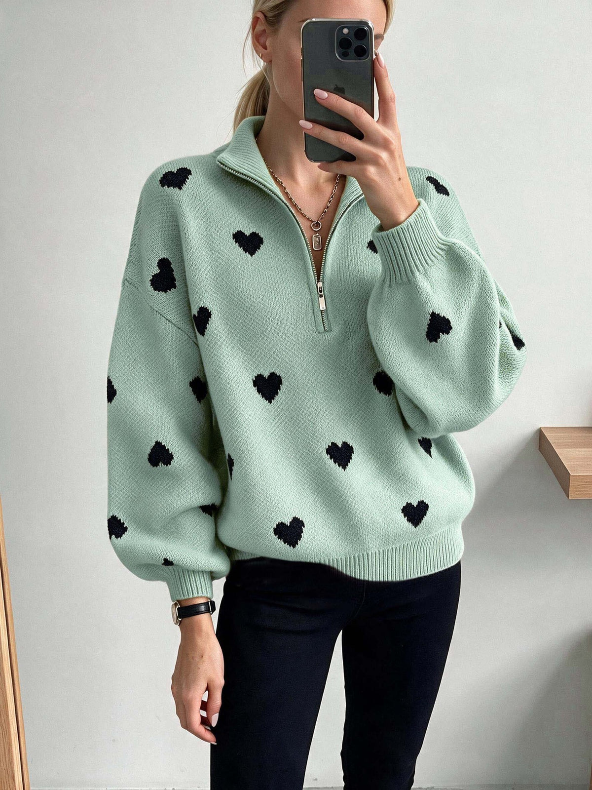 Light green heart-pattern knit sweater with a quarter zip and voluminous sleeves.