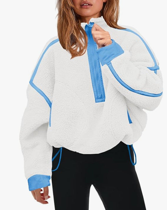 White plush zip sweatshirt with blue zipper and contrast trim at cuffs and hem.