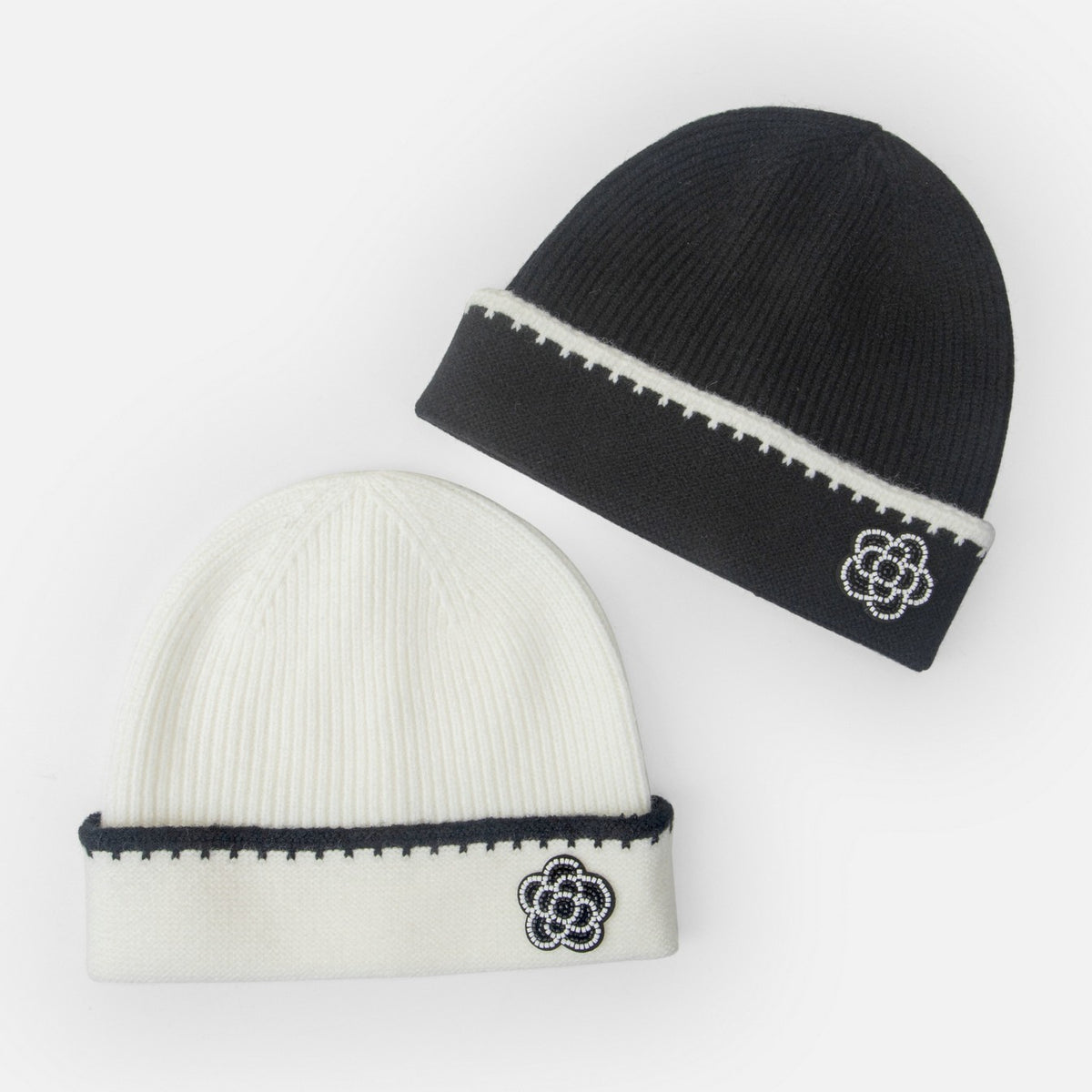 Set of two knit beanies: white with dark trim and black with white stripe