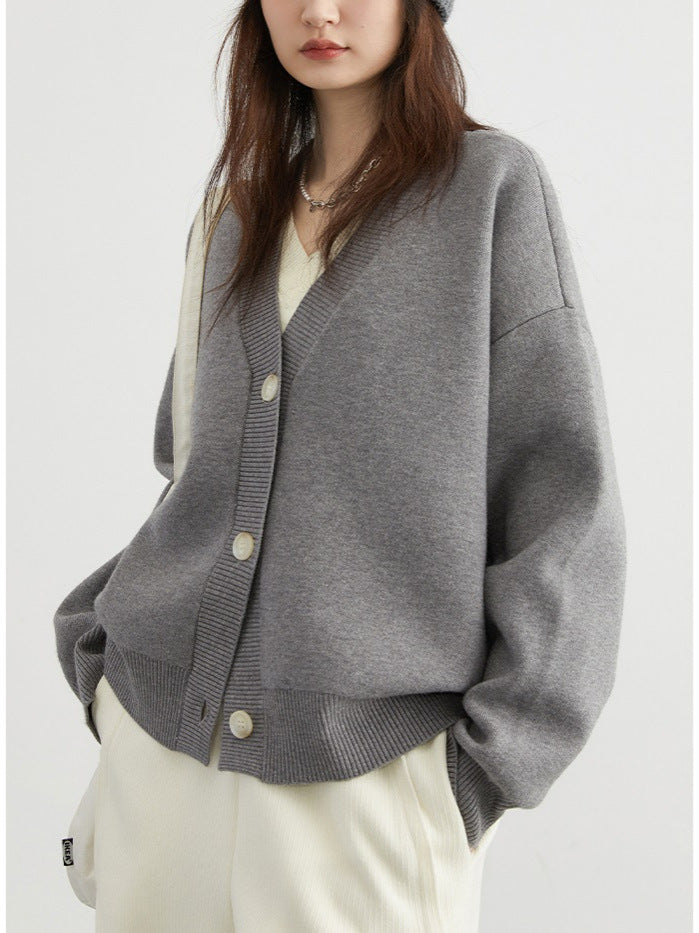 Light gray V-neck cardigan sweater with button front and ribbed cuffs, long sleeves
