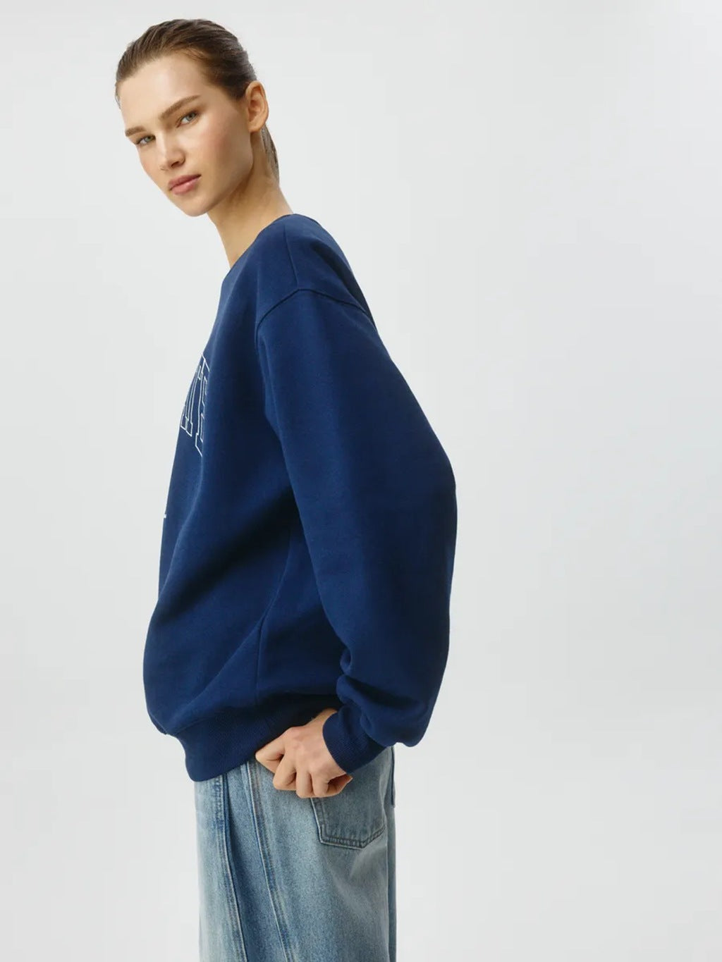 Dark blue crewneck sweatshirt, side view with long sleeves