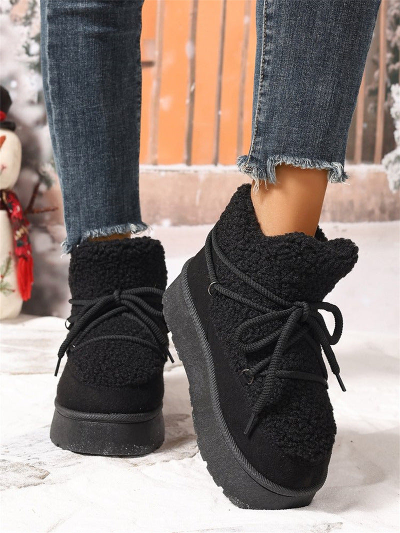 Black fleece-lined platform lace-up snow boots with textured sherpa cuffs