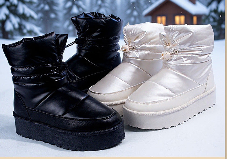 Women's snow boots in black and off-white, mid-top with thick platform soles