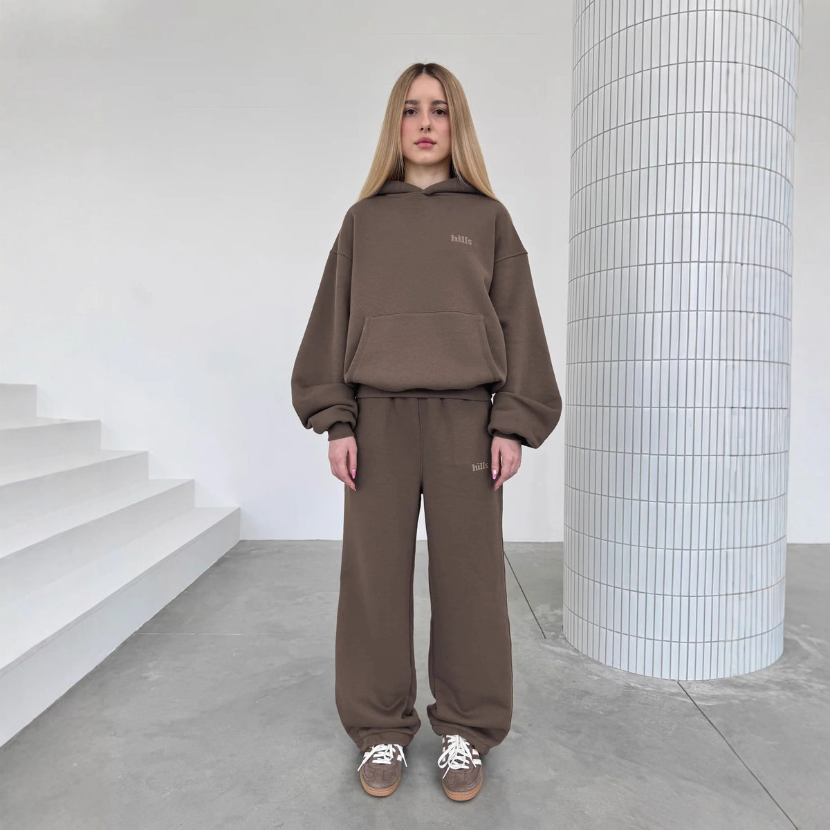 Loose-fit hooded pullover sweatshirt in dark brown, with kangaroo pocket and chest text print