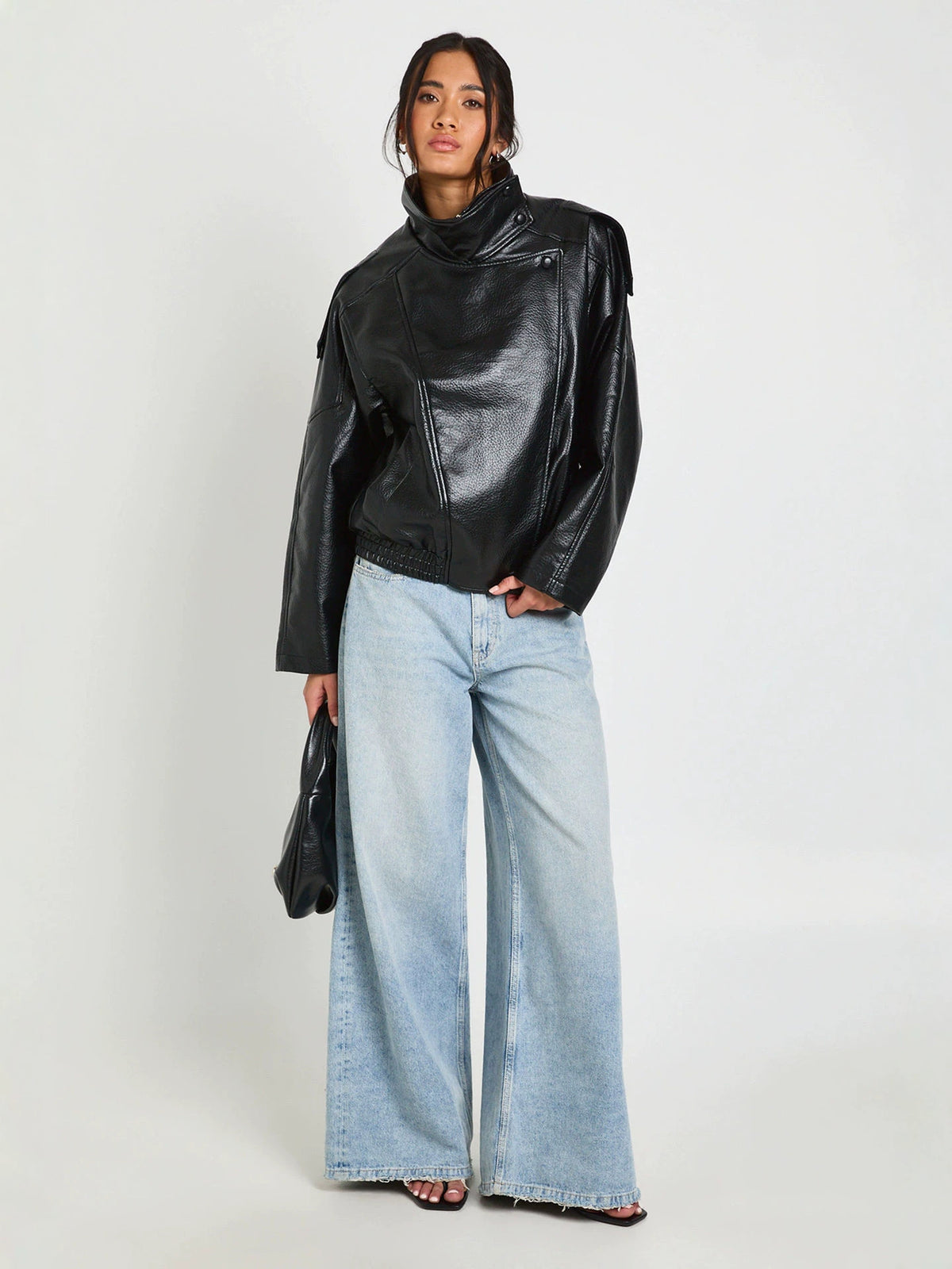 Black PU leather stand-up collar cropped jacket with zip front and relaxed fit.