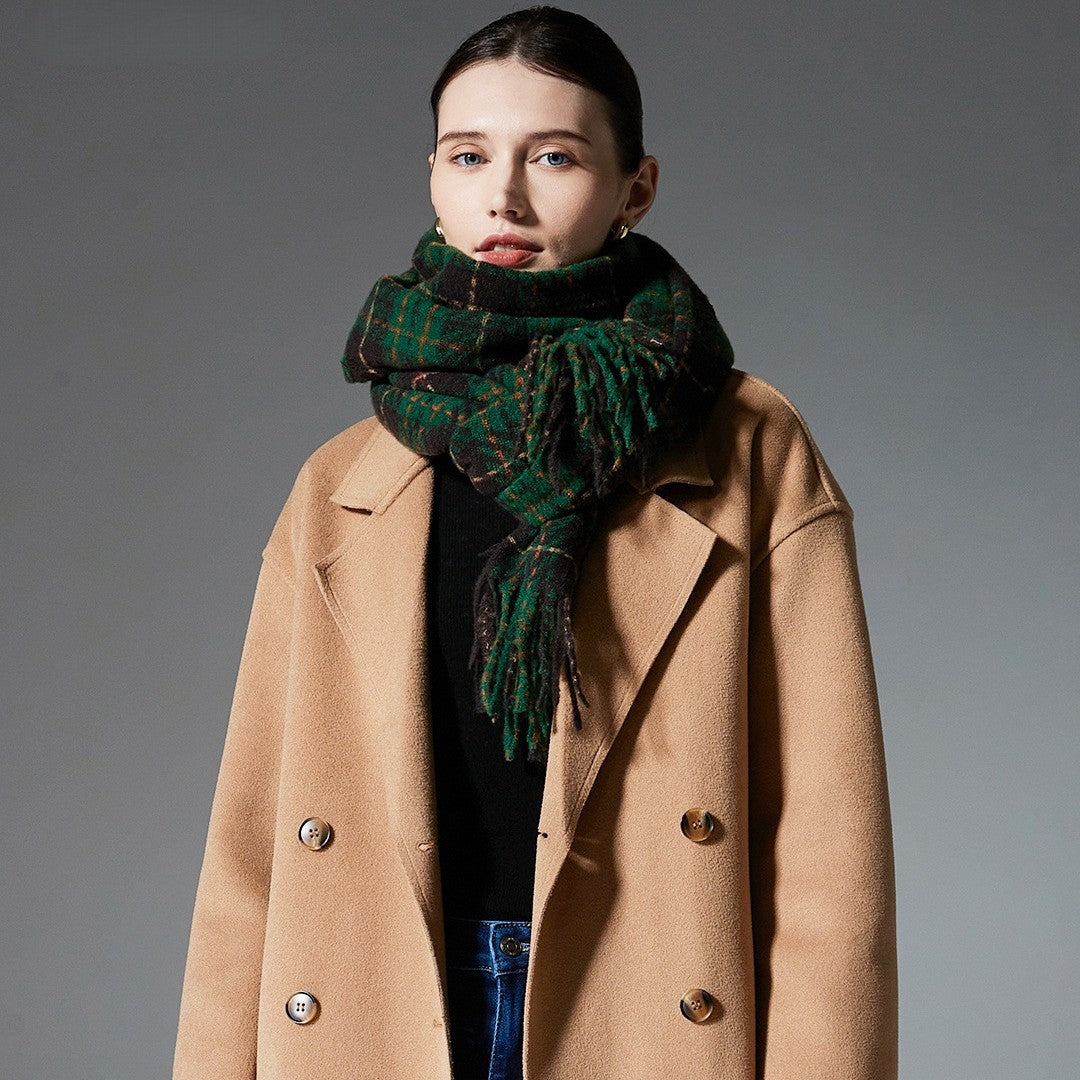 Green plaid scarf with tassel fringe, wrapped around neck