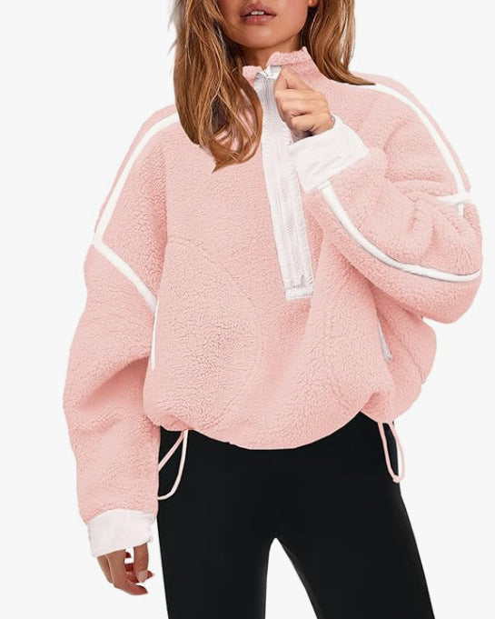 Pink plush zip sweatshirt with white zipper and contrast striped trim on sleeves.